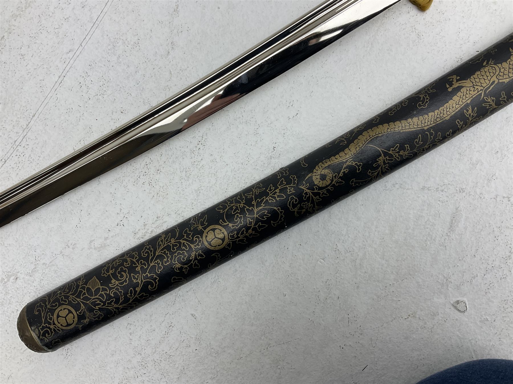 Reproduction Japanese katana with 63cm slightly curving fullered steel blade, ornate tsuba, cord bound grip and gilt transferred black saya L92cm; and two fencing foils, one marked Leon Paul (3)