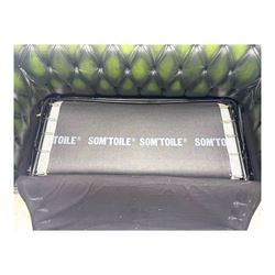 Two seat Chesterfield design sofa bed, upholstered in emerald green leather with deep-buttoned detailing, rolled arms, two loose seat cushions, and pull-out 