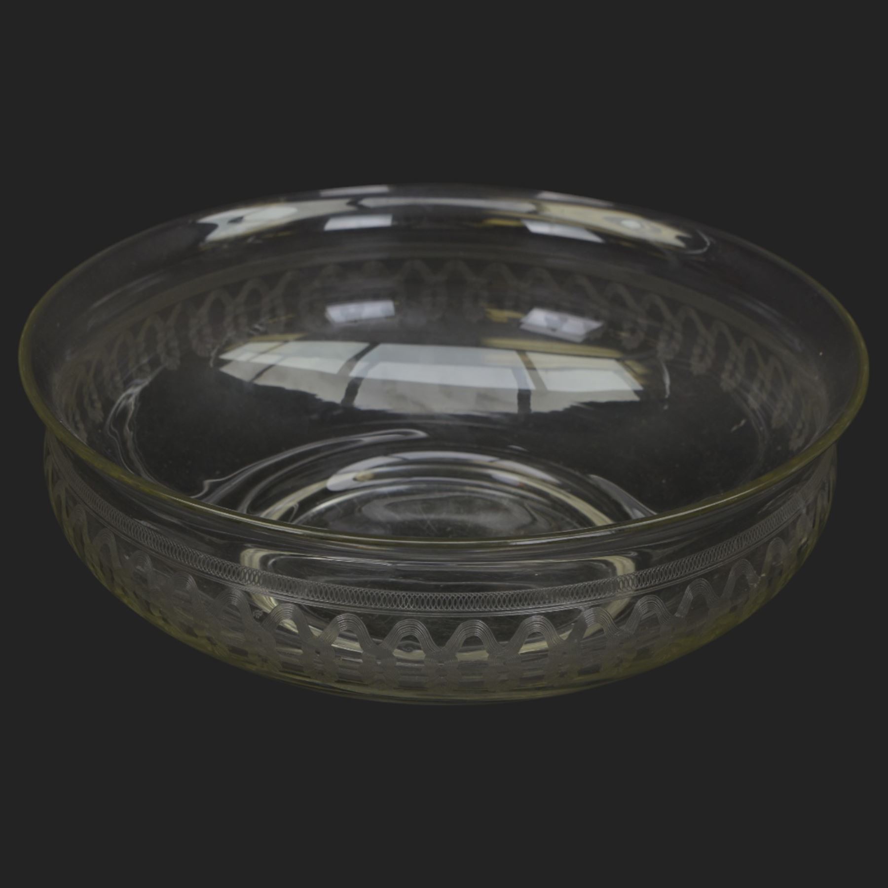 Edwardian glass wash jug and bowl, each engraved with looping border, jug H31.5cm, bowl D39.5cm