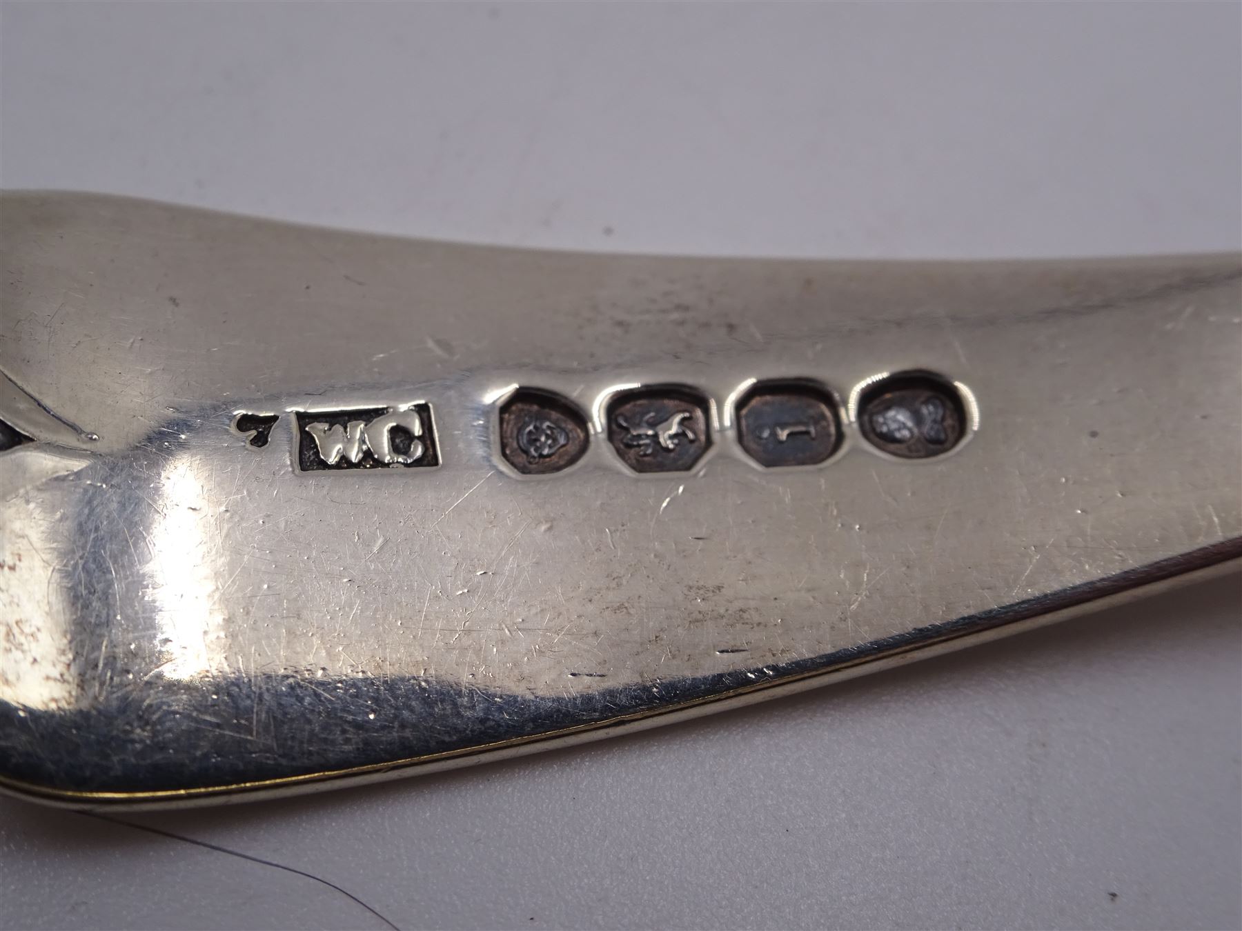 George III Old English pattern sauce ladle, with engraved crest and foliate decoration front and verso, hallmarked George Smith (IV), London 1799, together with an Old English pattern toddy ladle, with reed border and engraved griffin crest, hallmarked London 1824, maker's mark WC, probably William Chawner II, and two silver Fiddle pattern sauce ladles, the first example hallmarked London 1835, maker's mark worn and indistinct, and the second example hallmarked Charles Shipway, London 1837