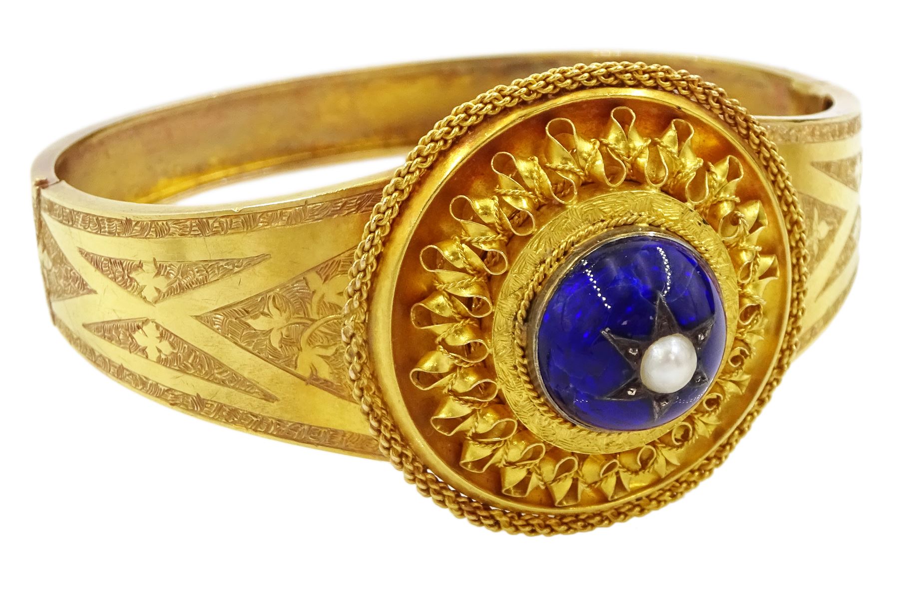 Victorian 18ct gold enamel and seed pearl hinged bangle and matching brooch, each star set with a seed pearl and blue enamel dome within a circular cannetille frame, each with a glazed panel verso, the hinged bangle with foliate engraved decoration, in fitted case
