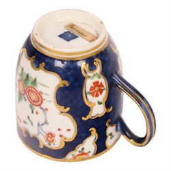 18th century Worcester coffee cup and saucer, circa 1770,  painted with shaped panels of chrysanthemums and banded hedges on a blue scale ground with gilt detail to the rim, mark beneath, H8cm 