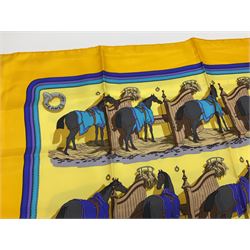 Hermès 'Ecuries' silk scarf, designed by Hugo Grygkar in 1947, printed with twenty horses in their respective stables, on yellow ground contained within stitched effect blue and purple and darker yellow gold borders, with rolled hand stitched edges and Hermes material label, 87cm square