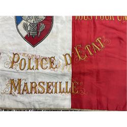 French State Police banner as the tricolor flag embroidered with coloured and metallic thread 'Societe De Secours Mutuels Un Pour Tous Tous Pour Un De La Police D'Eteat De Marseille' to one side; plain flag verso; tassels to three sides 100 x 113cm