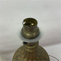 Gilt metal table lamp, heavily embossed with flowers and butterflies, with fluted frosted glass shade, H56cm