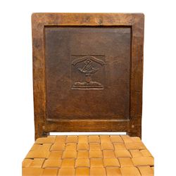 Mouseman - circa. 1930s set of six (4+2) oak dining chairs, panelled back carved with the Bagshawe family crest, the moto 'Forma Flos Fama Flatus' over an arm grasping a bugle-horn with ribbon tie and Yorkshire rose motif, adzed frame, leather lattice strap seat, on octagonal supports united by stretchers, two carvers and four side chairs, each carved with mouse signature, by Robert Thompson of Kilburn 

Provenance: Owned since manufacture by the Bagshawe family, descendants of the Staithes Group Artist Joseph Richard Bagshawe RBA (1870-1909).