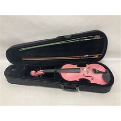 Zest full size pink violin, with a solid wood body and maple head, with matching pink bow and two further bows, in a hard case Length 60cm