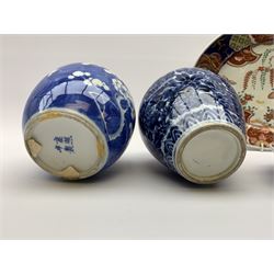 Early 20th century Chinese blue and white ovoid form jar and cover, the body and cover decorated with scrolling Lotus, H18cm, early 20th century Chinese ginger jar decorated with prunus, Japanese Meiji oval dish decorated in the Imari pallet, L36.5cm, pair of Japanese Imari plates and a pierced hardwood stand (6)