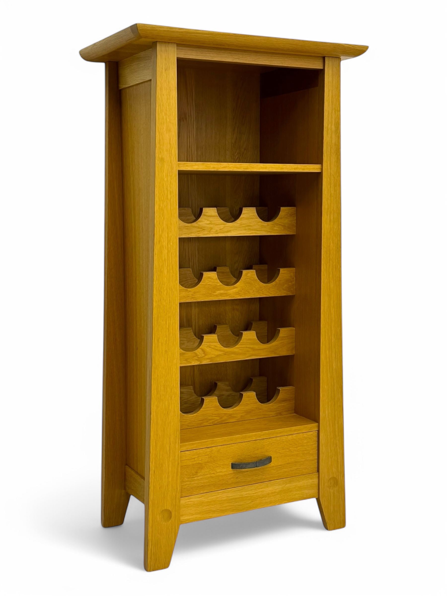 Contemporary light oak wine cabinet, rectangular overhanging top above an open shelf, fitted with four bottle racks each holding three bottles, single drawer with curved metal handle, on chamfered supports