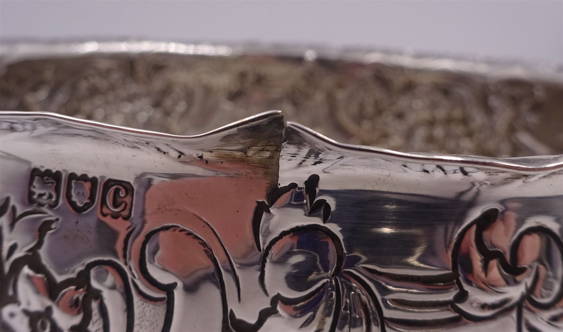 Late Victorian silver rose bowl, of circular form with embossed foliate and C scroll decoration, and engraved personal dedication, upon a part fluted spreading circular foot, hallmarked Wakely & Wheeler, London 1898, H11.5cm D18cm, approximate weight 11.67 ozt (363.2 grams)