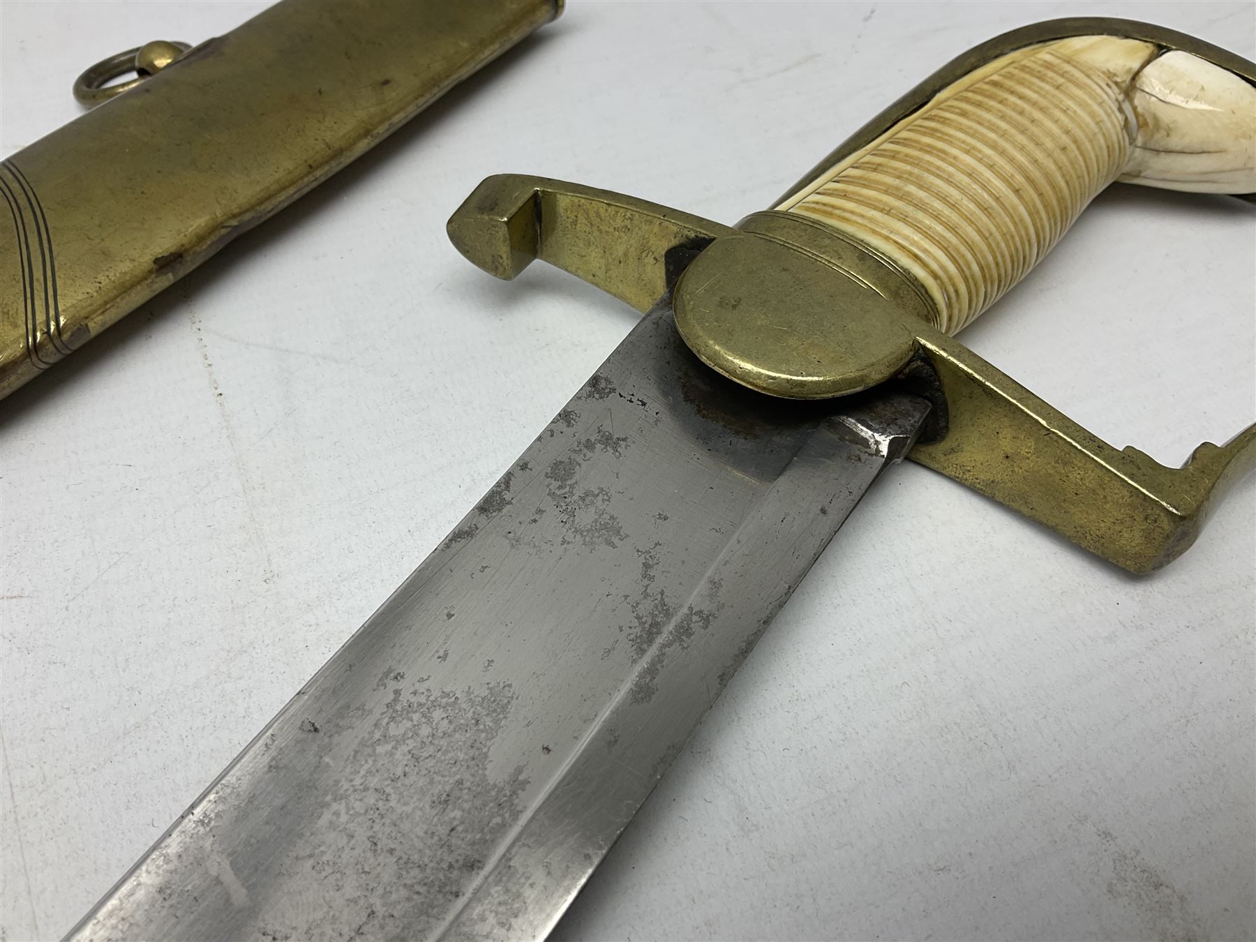 British pattern 1796 Light Cavalry Officer's sword, the 83.5cm curving steel blade marked 'W. Parker London' and 'Warranted' verso, brass stirrup hilt with half-round langets, knucklebow and backstrap with ribbed ivory grip; in brass mounted leather covered scabbard with two suspension rings L97cm overall. This item has been registered for sale under Section 10 of the APHA Ivory Act 
