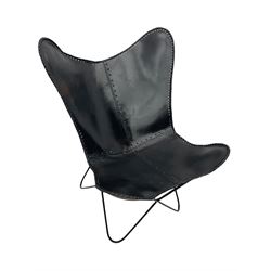 Metal framed butterfly chair upholstered in slung dark tan stitched leather 
