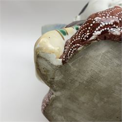 Japanese Fukusuke good fortune figure, modelled as a kneeling male figure holding a fan, dressed in traditional Samurai robes, H15.5cm