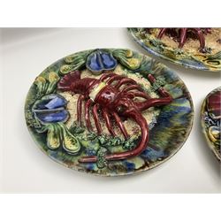 Five 20th Century Portuguese Palissy style Majolica wall plates, all depicting crustaceans to the centre modelled in relief surrounded by encrustations and shells, both with impress marks beneath, largest D29cm