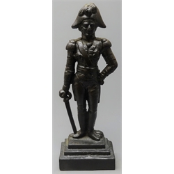  Cast iron fireside figure of Wellington depicted standing resting on his sword, on stepped base H41cm  