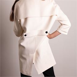 Burberry London - wool coat in cream, with concealed front popper fastening, bracelet-length sleeves with tab and black button detail and side slip pockets, with slit to back, size 40, unused with original Harvey Nichols garment bag and hanger