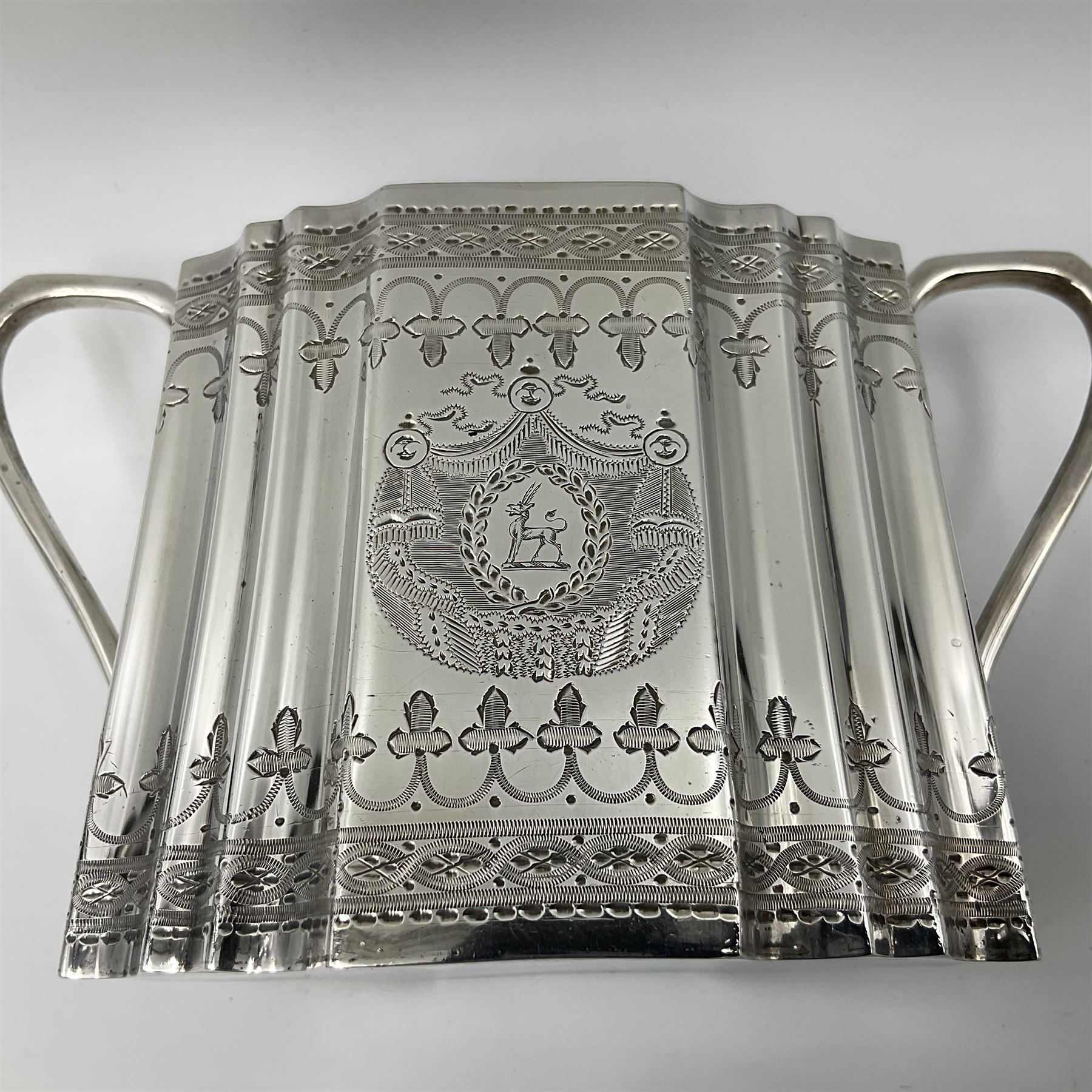 Victorian three-piece silver tea service, comprising teapot, twin handled open sucrier and milk jug, of oval form with shaped rim and C handles, each engraved with crests and bands of strapwork decoration, the milk jug and sucrier with gilt interiors, hallmarked Josiah Williams & Co, Exeter 1881, the teapot with ivory insulators and finial, all contained with a tooled leather, blue silk and velvet lined fitted case, retailed by West & Sun, Dublin 
This item has been registered for sale under Section 10 of the APHA Ivory Act