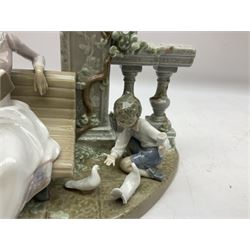 Lladro figure, Studying in the Park, modelled as a lady reading on a bench with child feeding fantail pigeons in front of a cherub statue upon square column, sculpted by Antonio Ramos, no 5425, year issued 1987, year retired 1991, H31cm