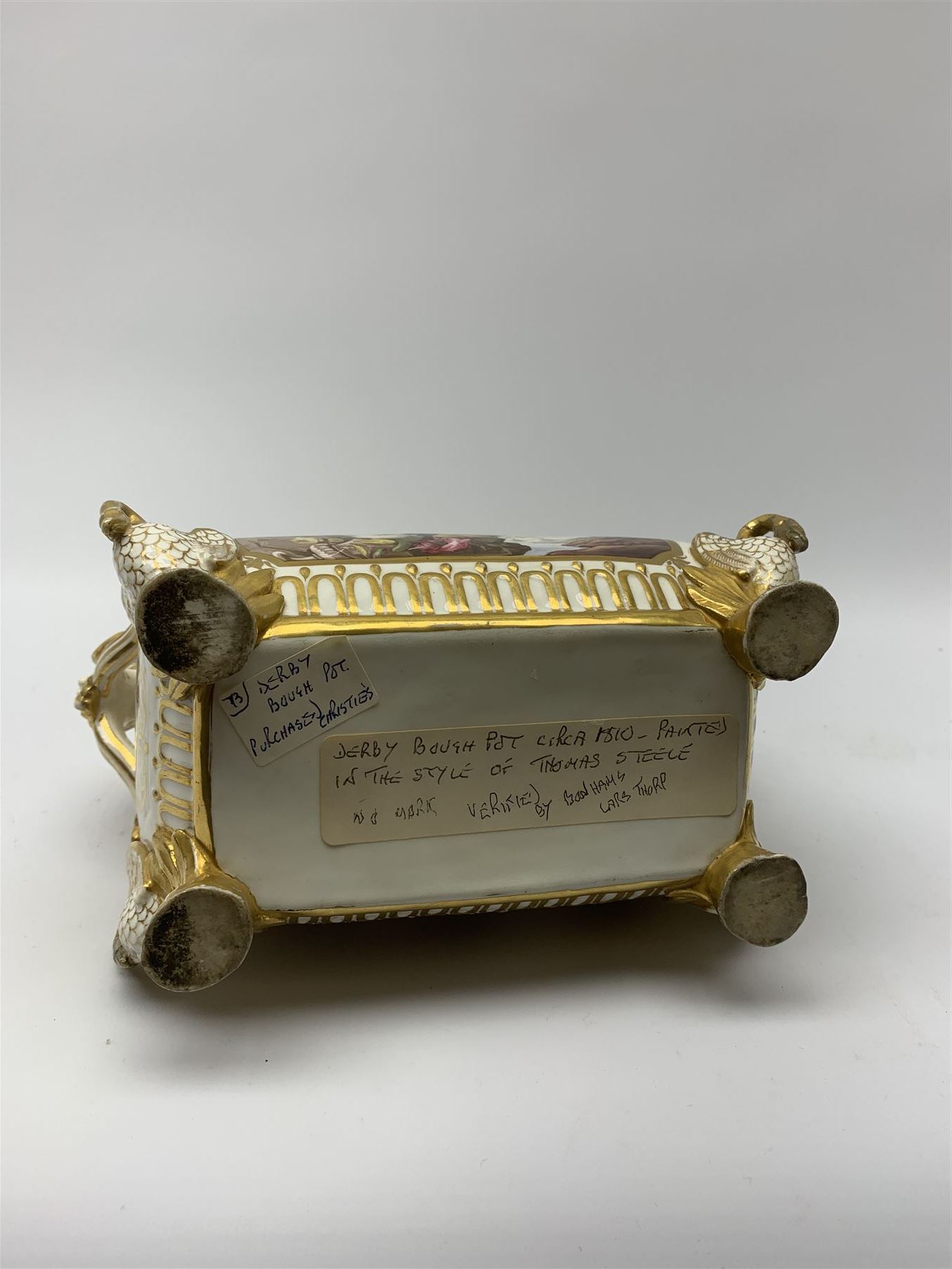 19th century Coalport bough pot, circa 1820, of bombe form, the body with twin handles surmounted by two birds and raised upon four feet modelled as swans, hand painted with two panels depicting an urn of flowers set against a mountainous landscape, the whole heightened in gilt throughout, H13cm L21cm