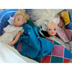 Two Sindy dolls, Barbie doll, Ken doll and one other, together with a collection of dolls clothes 