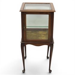Edwardian bijouterie two tier table, glazed top and sides with inlay surround, glazed door enclosing a single shelf and baized lined interior, raised on cabriole supports