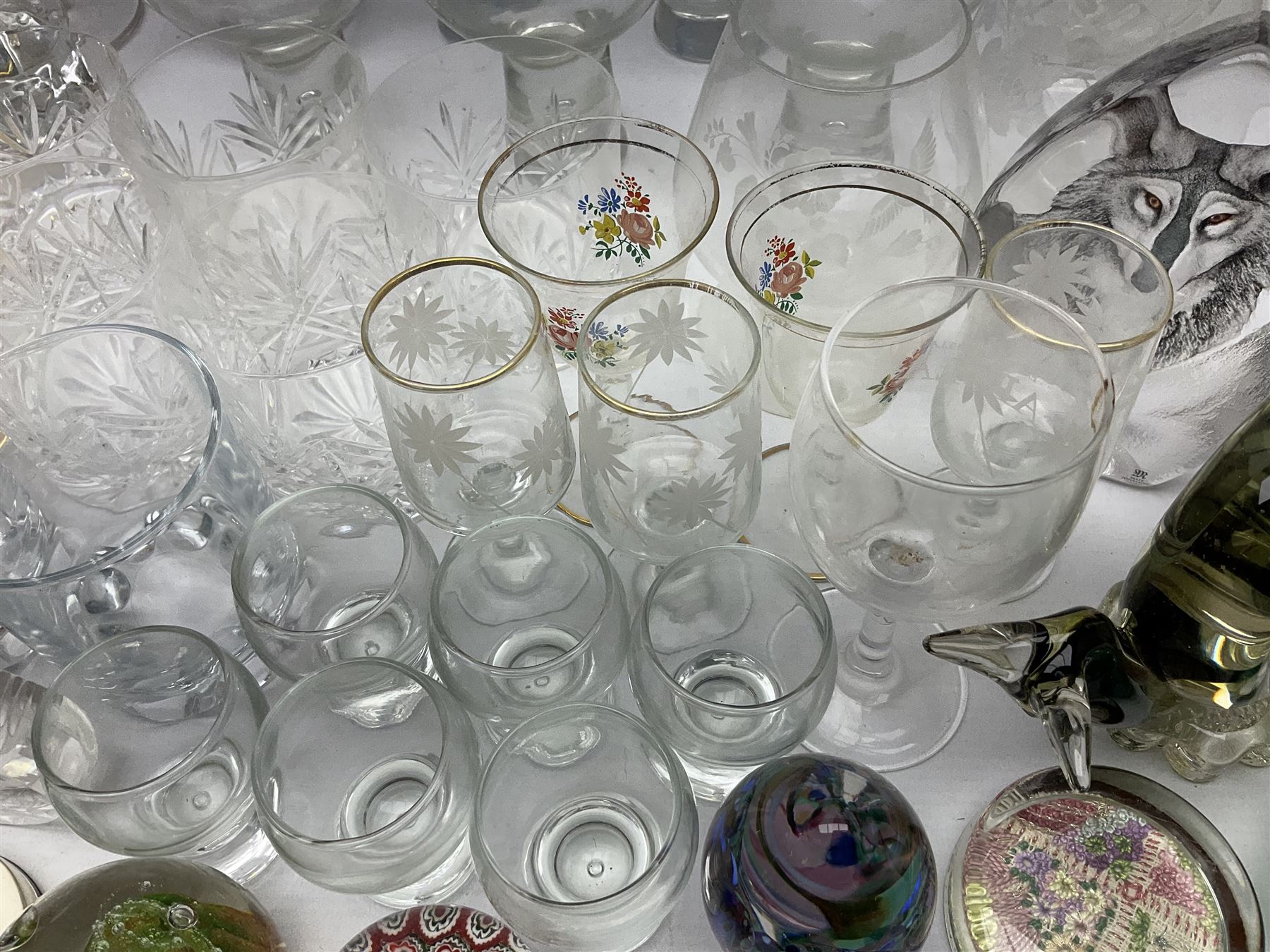Quantity of glassware to include Mats Jonasson colour wolf paperweight, Murano dolphin and flamingo figures, Caithness Dignity and Tango paperweights, set of six Edinburgh Crystal glass tumblers, art glass dish etc