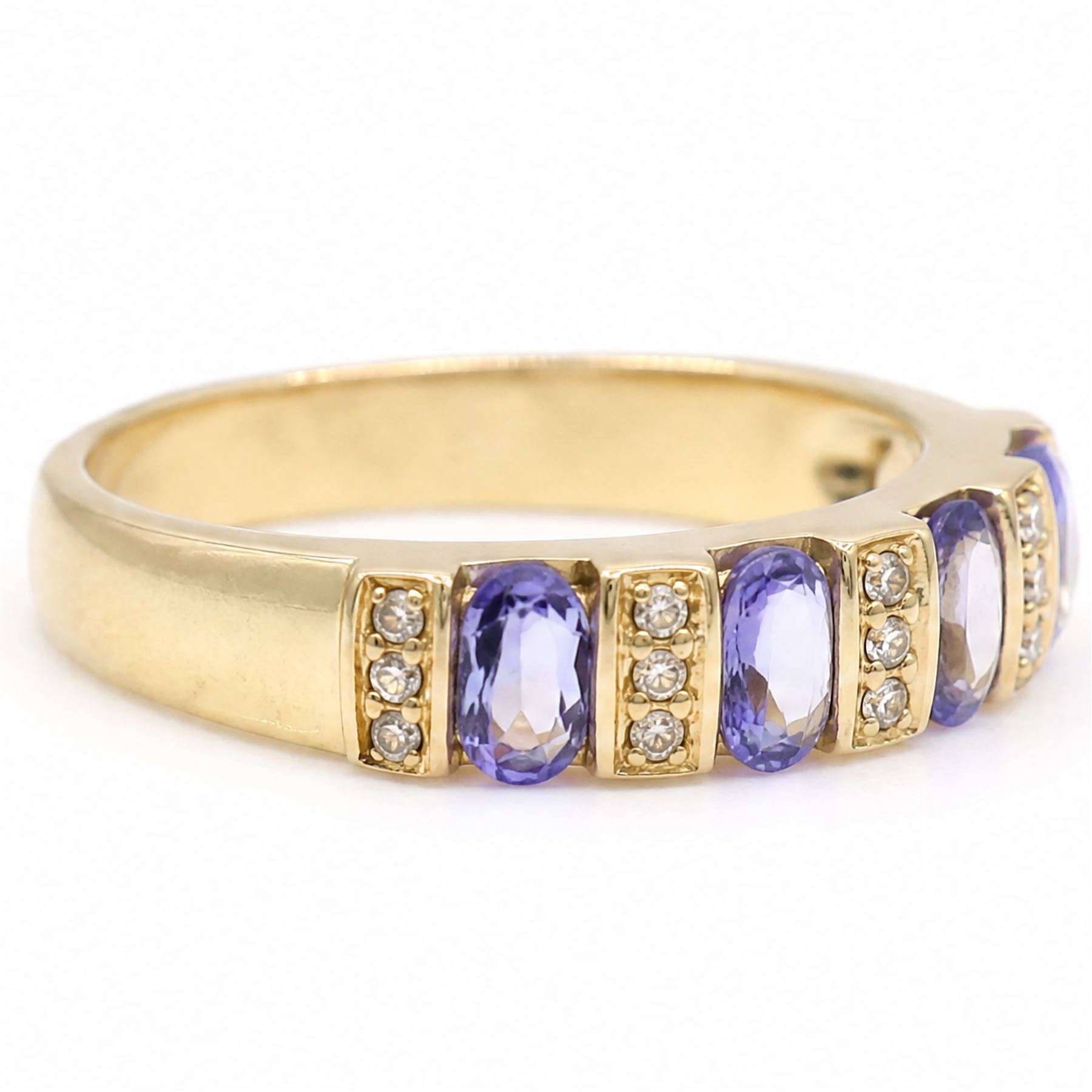 9ct gold tanzanite and diamond half eternity ring, four oval cut tanzanite's, each spaced by three single cut diamonds, hallmarked