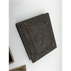A Victorian ambrotype photograph in gilt surround and Vulcanite type Union case, decorated in low relief to front and verso with a female figure upon horseback, H12.5cm, together with a leather case daguerreotype, and a further loose example. (3).  