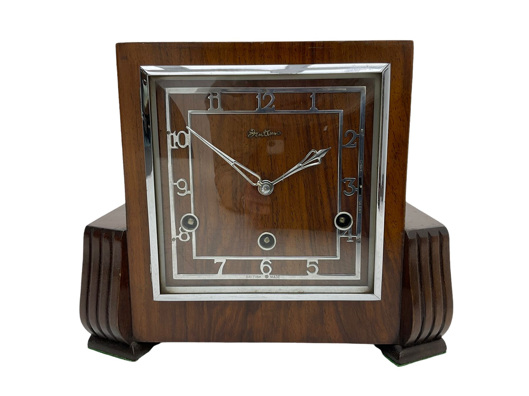  A  1930s “Bentima” Westminster chiming English art deco mantle clock in a stylised mahogany case with a square dial, chrome Arabic numerals and corresponding pierced hands within a chrome bezel, three train Perivale movement chiming the quarters on 4 gong rods, strike/silent facility. With pendulum and key. H24 



