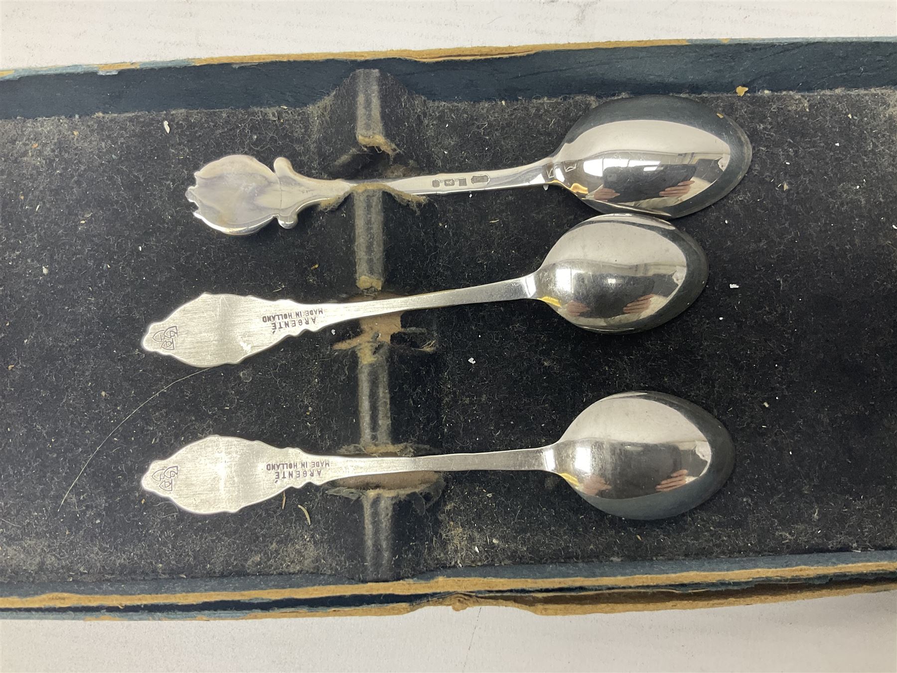 Silver plated tray, with shaped rim and embossed with a dog and crown to centre, stamped Valenti, together with three silver plated decanter labels, two port and one Bucellas, a plated cream jug with embossed floral decoration and a pair of plated fish knives engraved with double headed eagle to handle, tray W25.5
