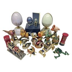 Romanoff Collection enamel egg, decorated with blue guilloche enamel set with paste stones, upon a gilded stand, in original box, together with a collection of similar novelty enamel trinket boxes, mostly modelled as animals, and two Heirloom Porcelain musical eggs, tallest H16cm