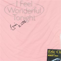 Signed Eric Clapton 2006 tour t-shirt, pink t-shirt with 'I Feel Wonderful Tonight' in silver lettering, signed by Eric Clapton in black marker to front, in framed display with ticket and programme, frame H83cm