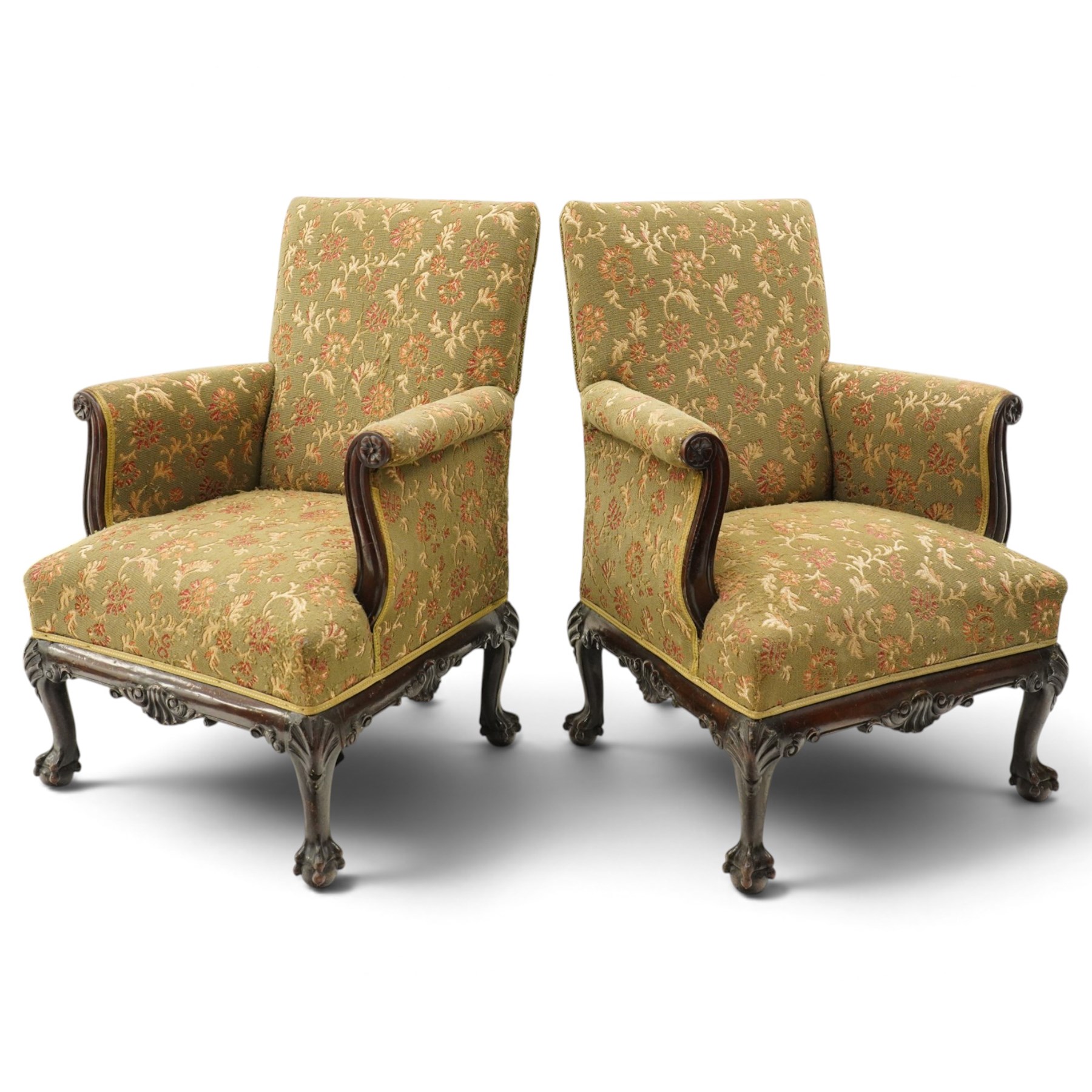 Pair of Chippendale design carved mahogany framed armchairs of stylised lyre form, high square backs and sprung seat upholstered in olive-ground foliate fabric, scrolled arm terminals with applied rosettes, the seat rail moulded with central scallop-and-acanthus motif, raised on shell-carved cabriole supports with ball-and-claw feet