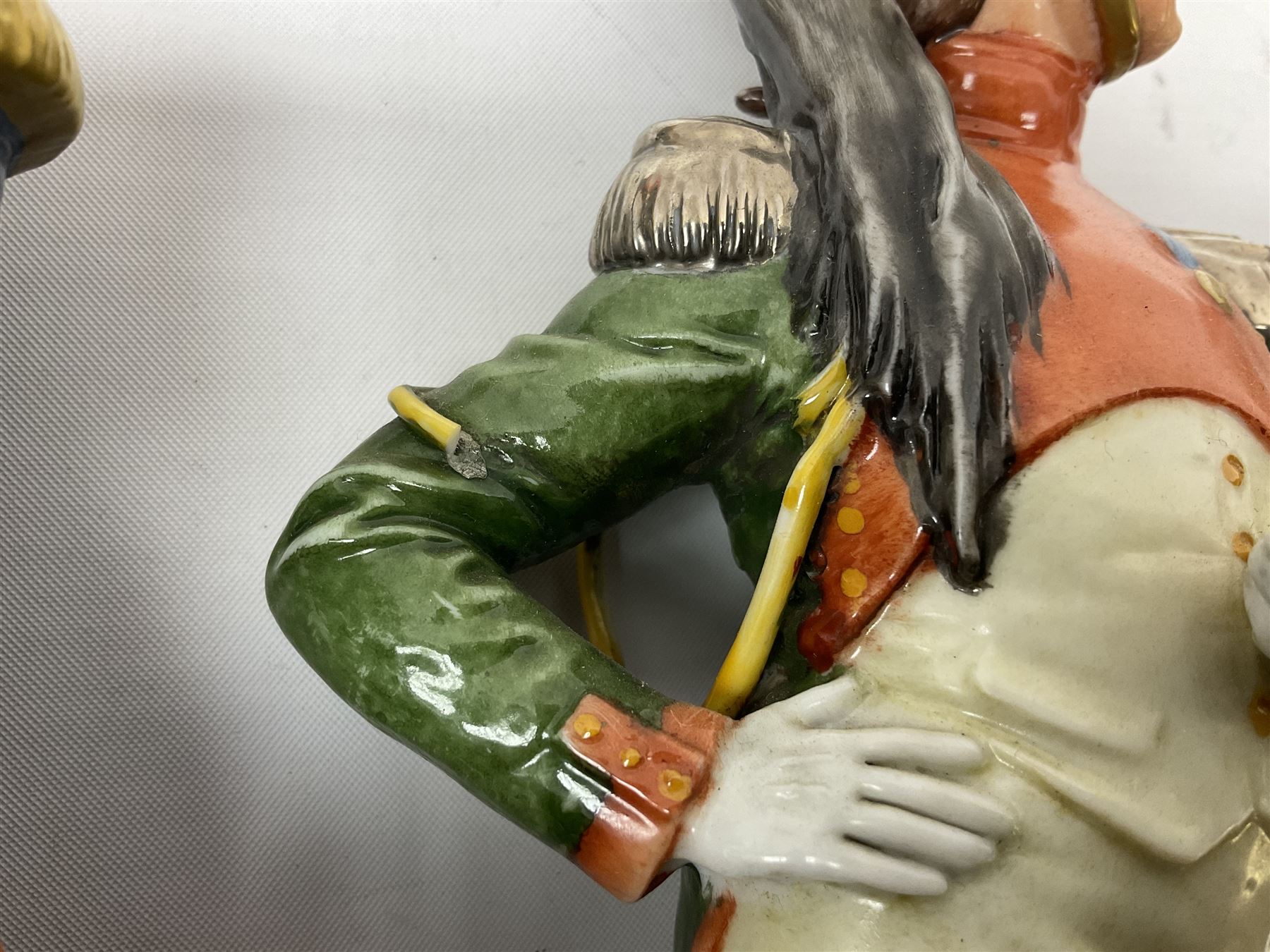 Group of seven Capodimonte figures of soldiers, to include four Bruno-Merli examples including Officer of the 12th Lancers 1820 and Captain of the 18th Hussars 1815, both raised upon ornate gilt plinths bearing British monarch motto in Latin 'Dieu et mon droit', and three further similar, all with crowned N mark beneath, tallest H32cm