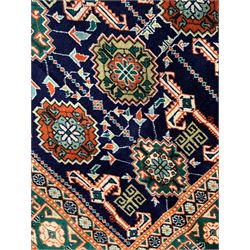 Small Persian indigo ground rug, the field decorated with Gilt motifs with trailing bead and stylised foliage, emerald green ground border decorated with geometric design and flower heads