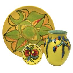 Poole Pottery charger, with a stylised floral pattern on a yellow ground, together with a Poole pin dish and vase of a similar style, vase H21cm