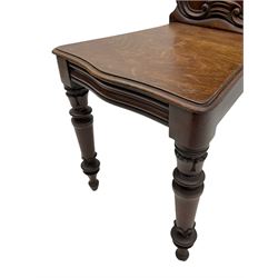 Victorian mahogany hall chair, shield panel back carved with c-scrolls and foliage, with crest cartouche mount depicting rampant lion on blue and yellow stripe, serpentine moulded seat, turned and carved front supports