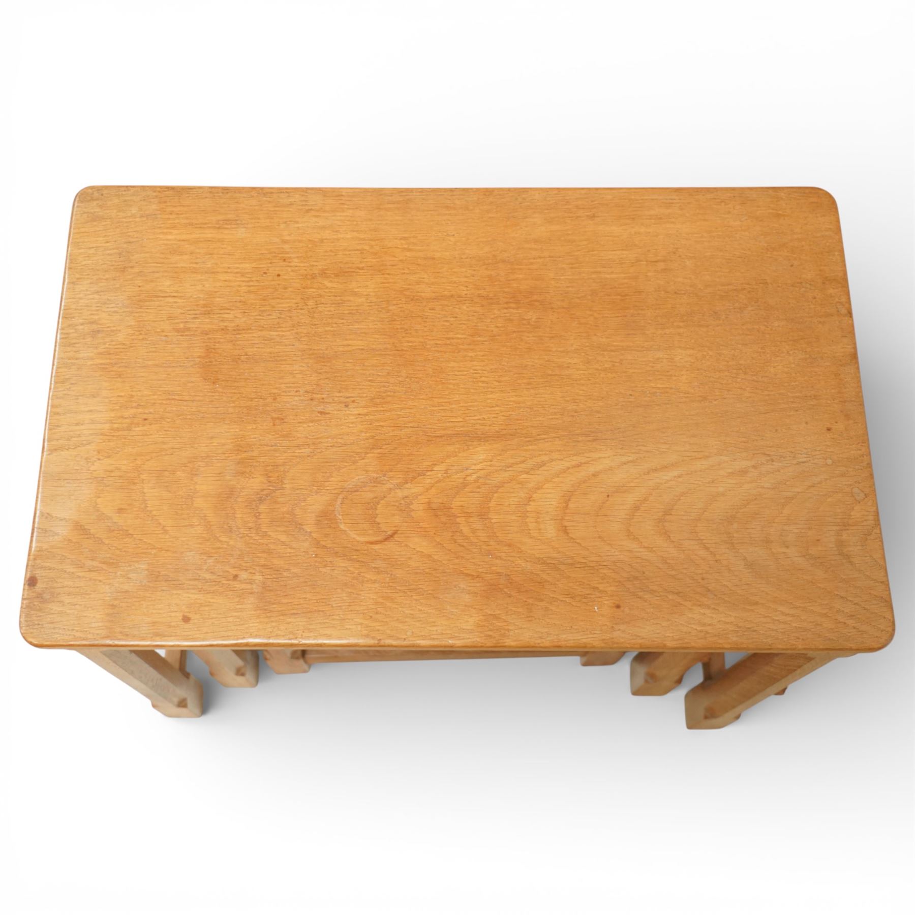Mouseman - oak nest of three tables, raised on octagonal supports, with carved mouse signature, by the workshop of Robert Thompson of Kilburn