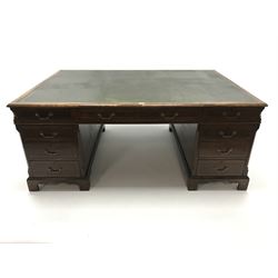 Large 20th century partners desk with dark green leather inset tooled top,  four short and two long drawers, two pedestal supports featuring three short drawers and two single cupboards
