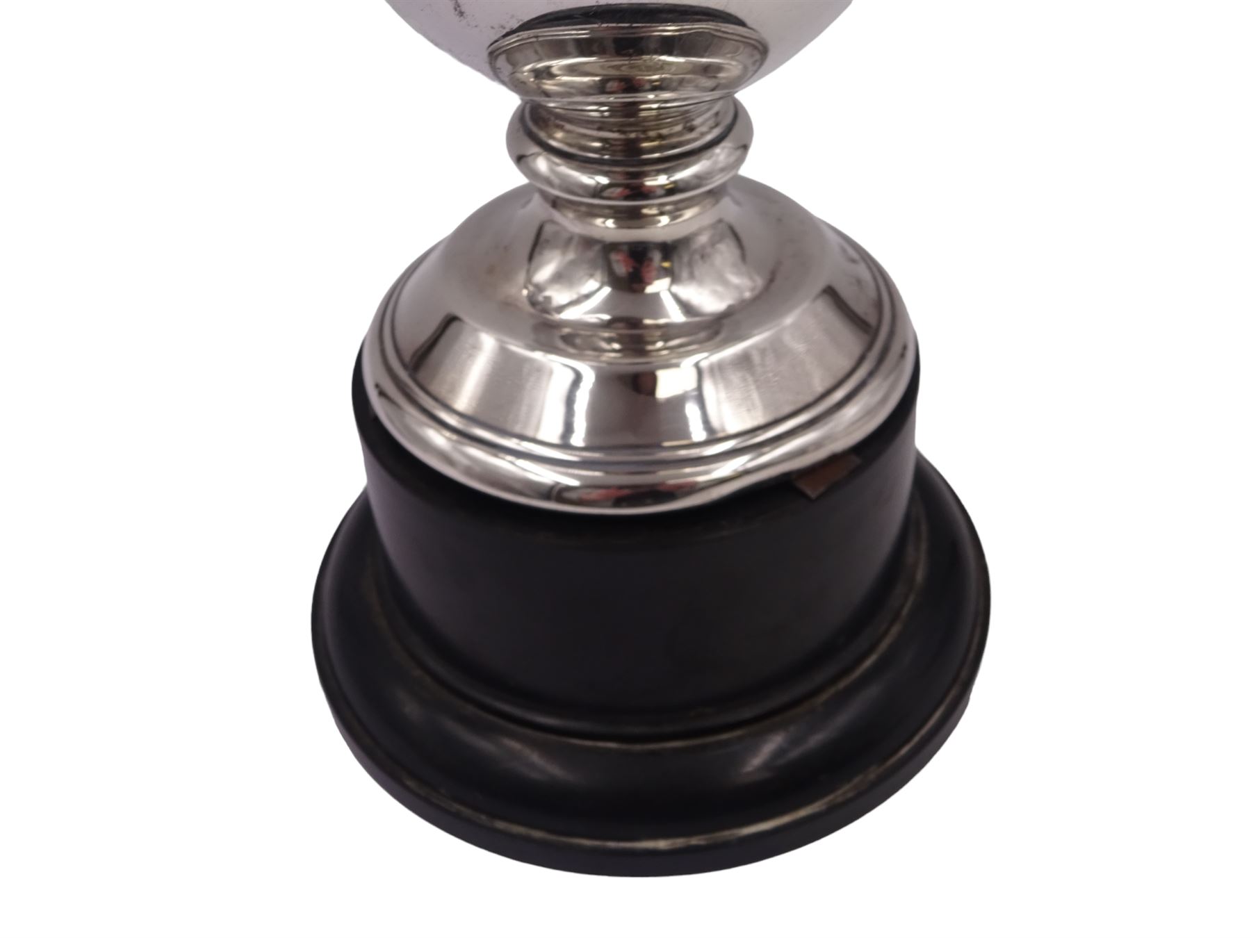 1920s silver trophy cup, with angular twin handles, upon knopped stem with circular spreading foot, the body with presentation engraving 'Burniston & District Show, presented by S Fox Linton TD MD, for the Best Agricultural Mare or Gelding, 10 miles radius, 1928' and engraved with winners verso, hallmarked Charles Boyton & Son 1921, upon black plastic base, including base 25cm