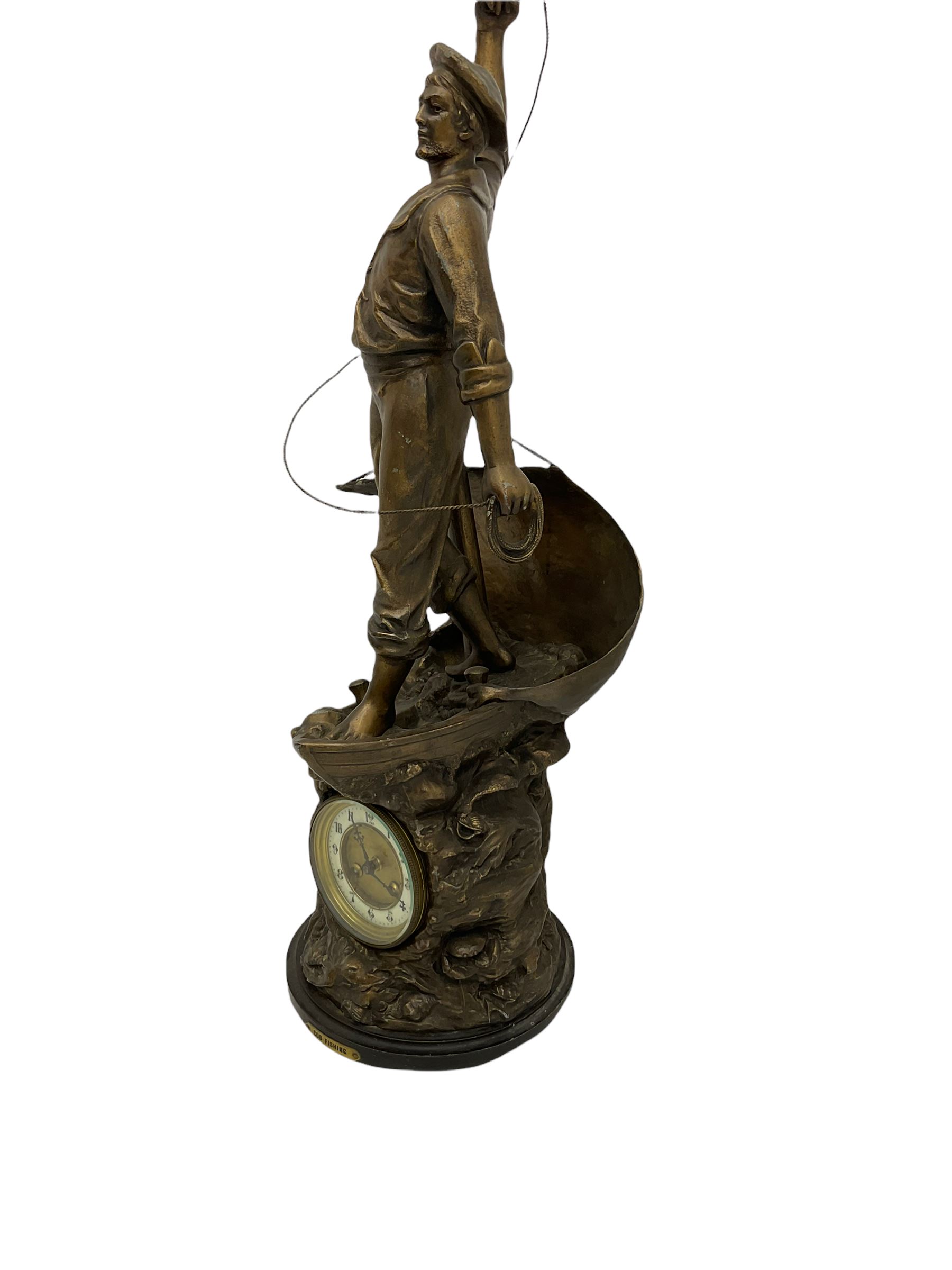 An imposing bronzed spelter clock depicting a 19th century  fisherman, on a circular ebonised base with a plaque entitled “Cod Fishing” with a Parisian eight-day striking movement striking the hours and half-hours on a coiled gong, two-part dial with a gilt centre, ivorine chapter inscribed with upright gothic Arabic numerals and minute markers, with steel gothic hands within a brass bezel and flat bevelled glass. With pendulum.   



