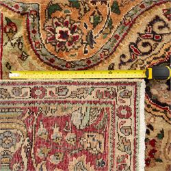 Azerbaijan rug, intricate central medallion in muted golds and greens surrounded by navy panels filled with boteh and floral designs, enclosed by a red main border featuring stylised boteh motifs, woven in the Caucasus region of Azerbaijan