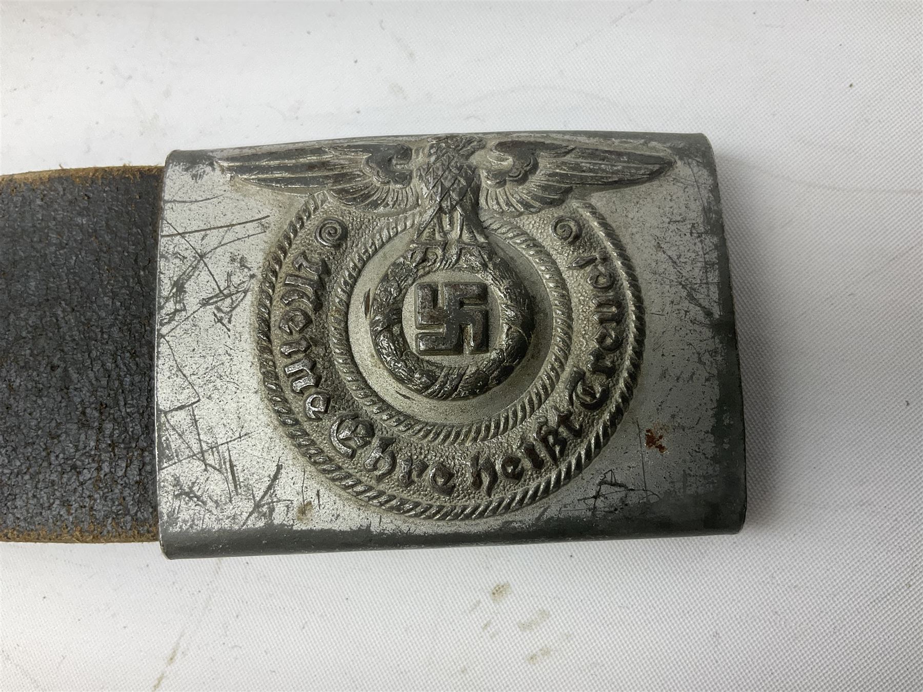 WW2 German 'SS' leather belt with six pouches (one containing unused field bandage) and buckle inscribed 'Meine Ehre Heifst Treue'; belt marked 0/0836 0029