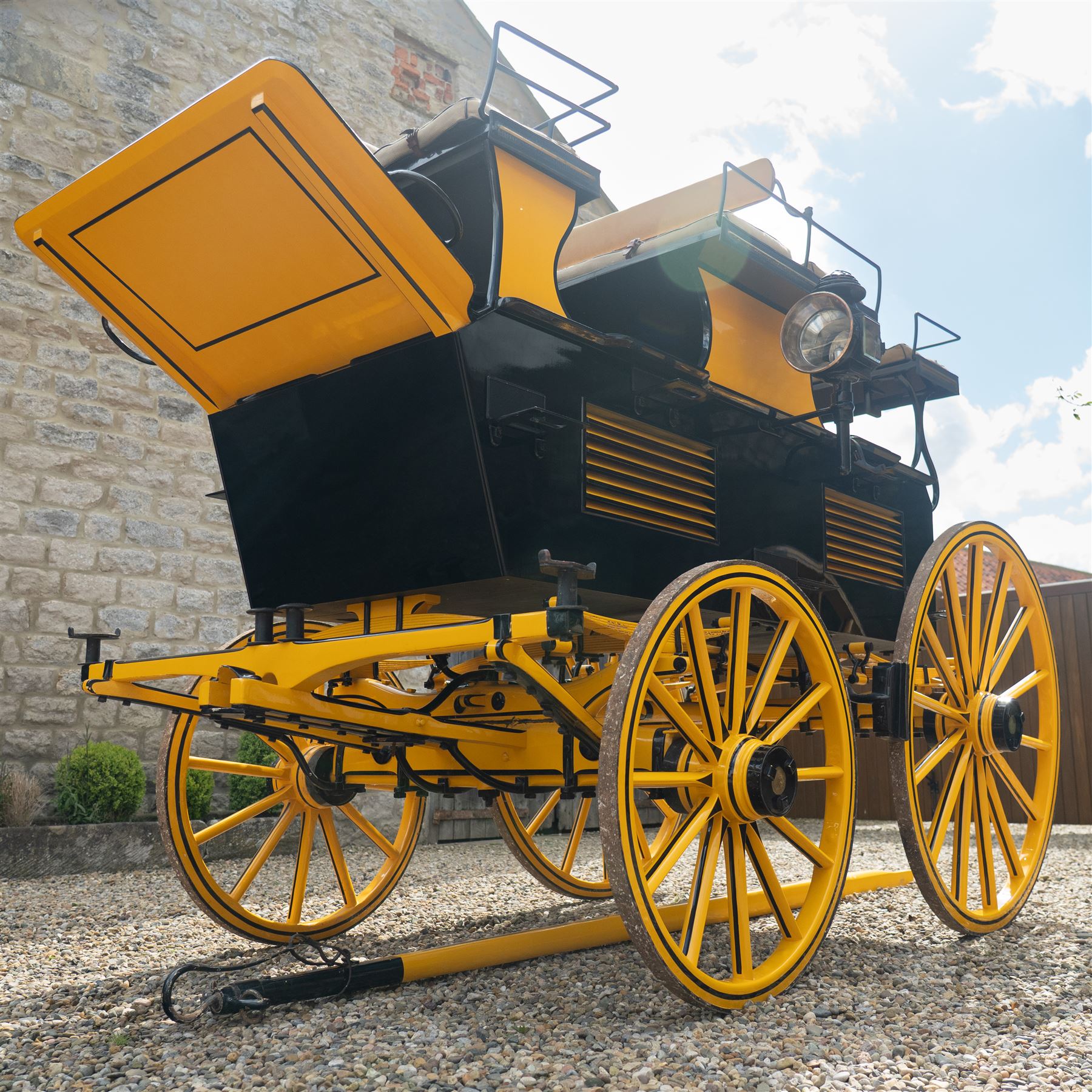 Roof Seat Break by Shanks of London

A roof seat break by Shanks of London built on a perch in black and yellow livery, the body fitted with an elevated driver's box seat, elevated rear groom's seat and central passenger compartment. The carriage is mounted on wooden spoked wheels with leaf spring suspension and is equipped with louvred underbody storage compartments, carriage lamp brackets (lamps next lot), folding access steps and a pole for driving with a pair or team of horses. The wheel hubs are stamped 