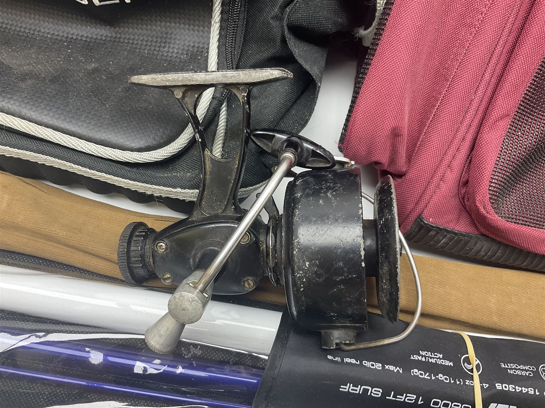 Collection of fishing memorabillia and equipment, including an Allcocks three piece split cane trout fly rod, Shakespeare Salt 3600 surf rod, two tackle bags, Old Red Seastreak multiplier reel, Sportext Saltwater fixed spool reel, fishing dvds, etc