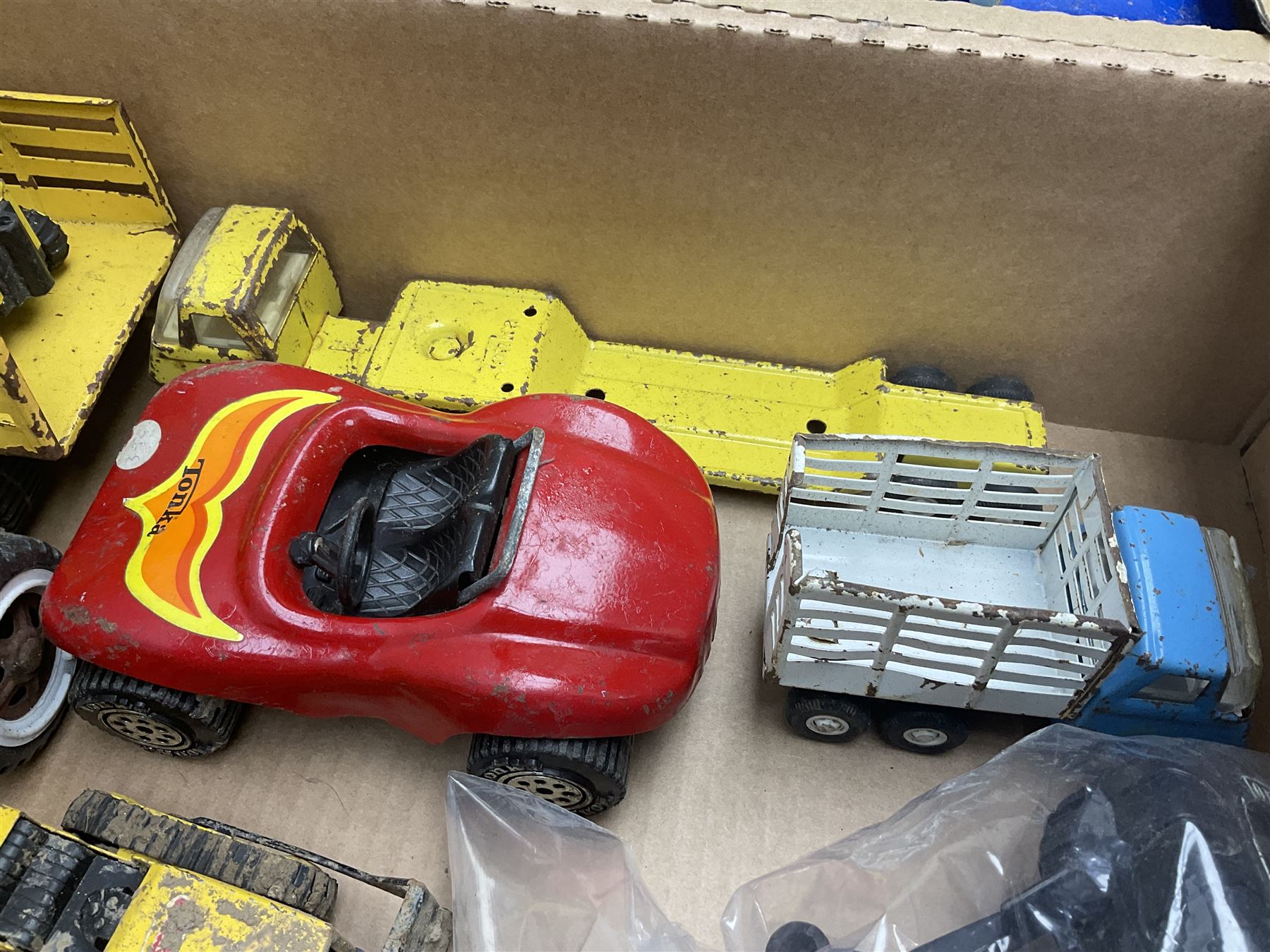 Tonka - fourteen pressed steel vehicles including Pick-up Truck, Tractor Digger, Mobile Crane, Trencher, Beach Buggy, two Bulldozers, Digger, Low Loader, Farm Trucks etc; and small quantity of spare parts (14)