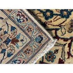 Persian Kashan ivory ground rug, wool with silk inlay, central floral rosette medallion surrounded by trailing flower heads and interlacing leafy branches, the repeating scrolling border decorated with palmettes, within guard stripes