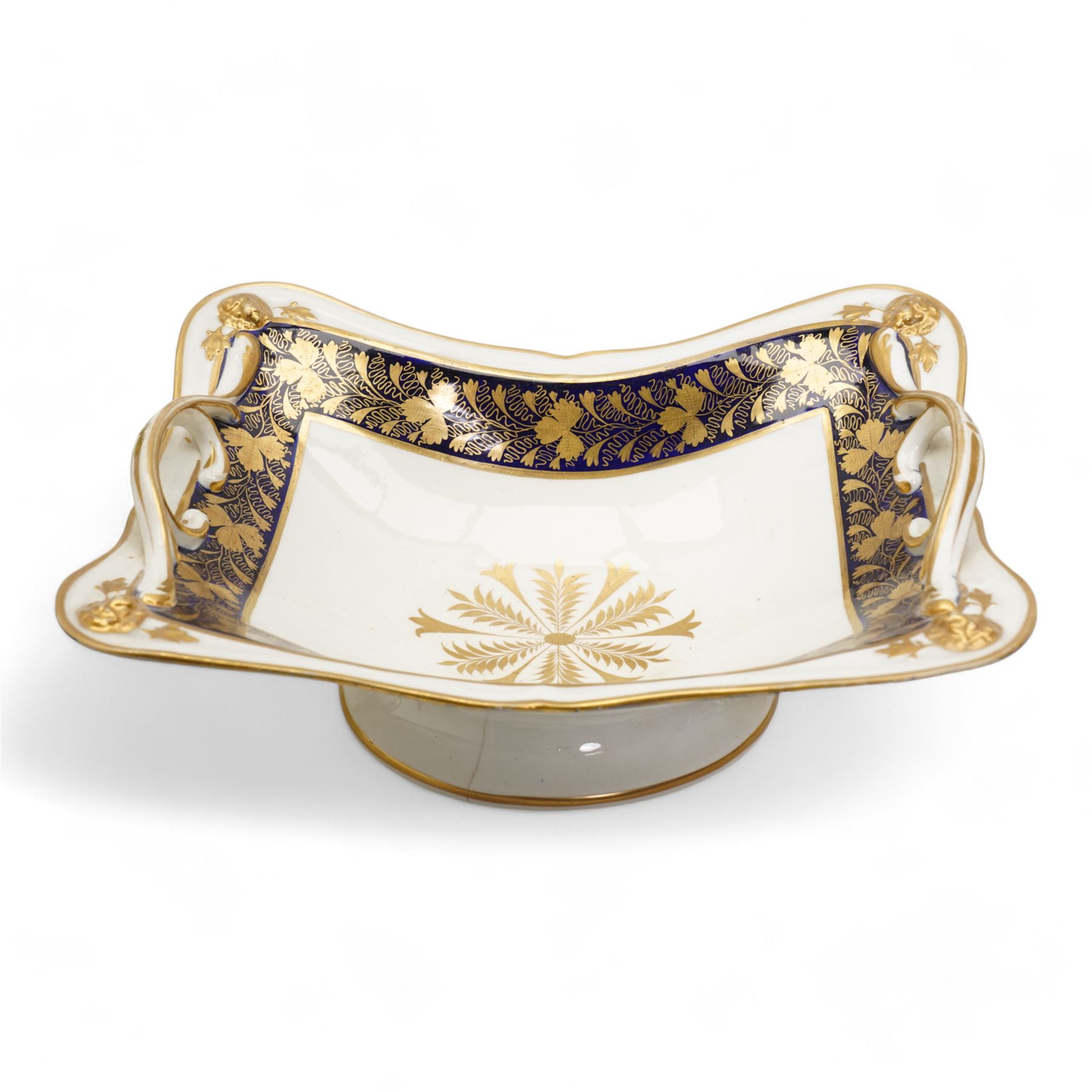 Large early 19th century Derby porcelain dessert basket, of rectangular twin-handled form, with cobalt blue and gilt decoration, painted marks beneath, L29cm together with a 19th century porcelain dessert service, decorated with floral sprays within a green and gilt border, comprising eight plates and three serving dishes, pattern no. 701/1