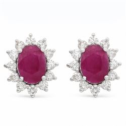 Pair of 18ct white gold ruby and diamond cluster earrings, each stud set with a single ova...