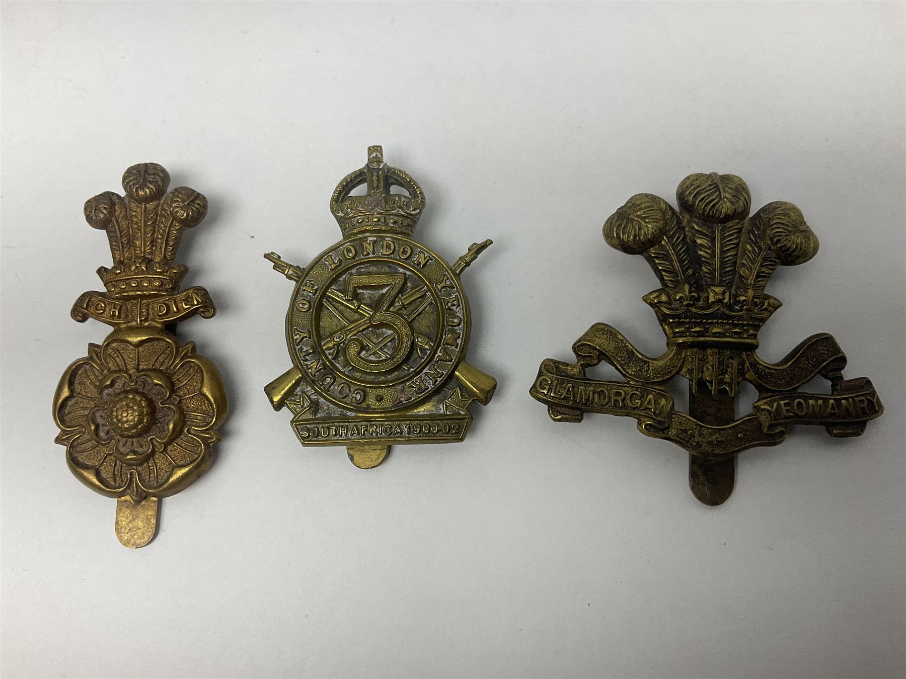 Nineteen Yeomanry metal cap badges including Derbyshire, Northamptonshire, Essex, Glamorgan, Staffordshire, City of London, Surrey, Shropshire, Hertfordshire etc; together with eleven Fusiliers badges including Lancashire, Royal Welch, Northumberland etc (30)